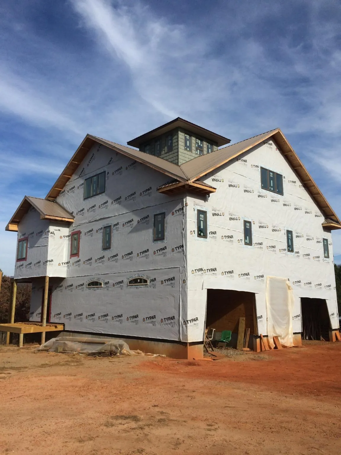 New two story house under construction with a cupola and gabled roofs in Rockaway Beach